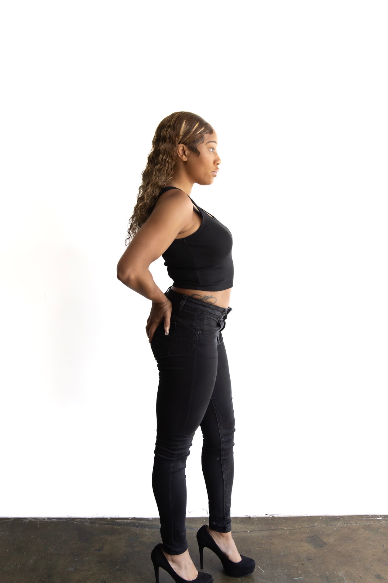 Profile agency digital of Taniya in a black tank and black jeans